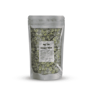 Stand-up silver pouch containing Ginger Mint candies with a white label reading 'two blues' on the front. The wrappers inside are green and white with text visible on the label.